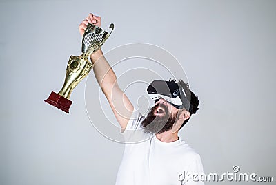 Championship online. Man bearded hipster vr headset holds golden goblet. Feel victory in virtual reality games. Achieve Stock Photo