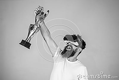 Championship online. Man bearded hipster vr headset holds golden goblet. Feel victory in virtual reality games. Achieve Stock Photo