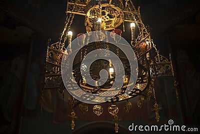 Chandelier in church. Golden chandelier in dark temple. Vintage interior Stock Photo