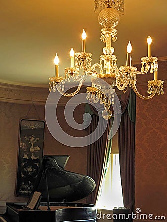 Grand piano and lighted chandelier Editorial Stock Photo