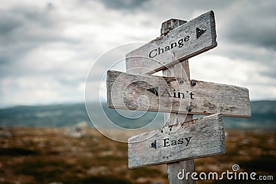 Change aint easy text on wooden rustic signpost outdoors in nature Stock Photo