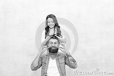 Change hairstyle. Raising girl. Create funny hairstyle. Child making hairstyle styling father beard. Being parent means Stock Photo