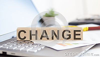 CHANGE Wooden cubes with letters on a laptop keyboard Stock Photo