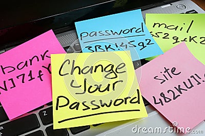 Change your password. Laptop with pieces of paper Stock Photo