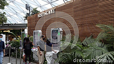 Changi Airport Jewel - Visitors buying attraction tickets Editorial Stock Photo