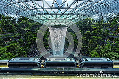 Changi,Singapore-November 30th,2019:An Aero train were seen passing by the HSBC water vortex at the Jewel Changi Airport.This is Editorial Stock Photo