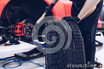 Changing car tire and wheel in the car mechanical service Stock Photo