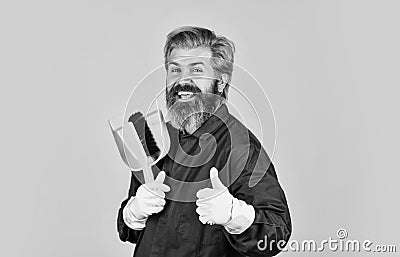 Changing responsibilities. Male janitor with cleaning supply. sweeping the floor. man cleaner. bearded man cleaning with Stock Photo