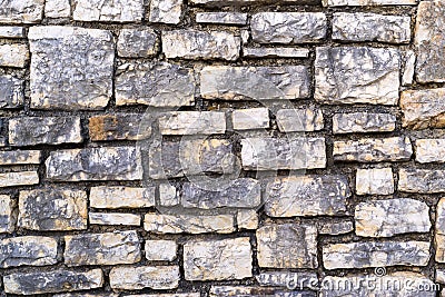 Channelled textured surface of a stone wall Stock Photo