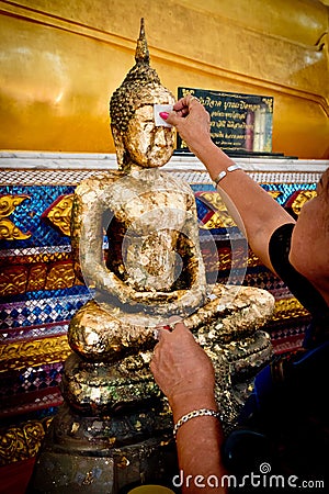 Chanthaburi , Thailand - MAY 11 : Thai Buddhist People doing cover Statue of Buddha with Gold Leaf. This is Tradition Culture Editorial Stock Photo