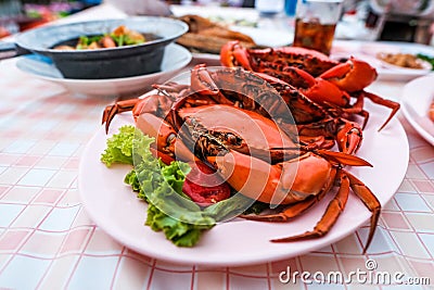 Many bright red steamed sea crabs Lined in a plate ready to serve for those who like to eat seafood. Stock Photo