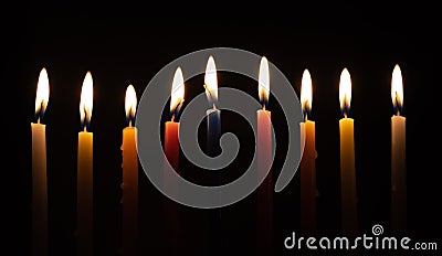 Chanukah candles glowing in the dark Stock Photo