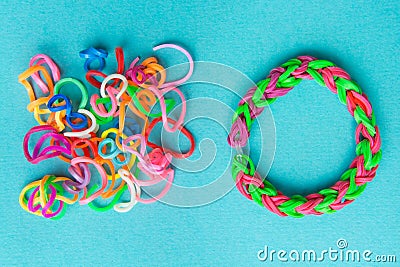 Chaos and order. Rubber bands for weaving loose and bracelet of rubber bands Stock Photo