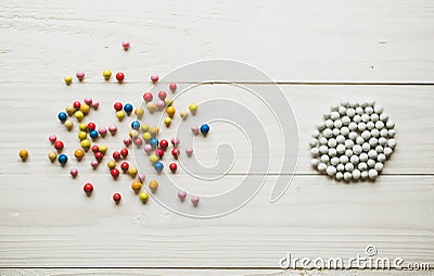 Chaotic colorful balls and organized white balls. Conceptual of Stock Photo