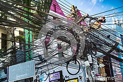 Chaotic intertwined mess of electricity wires Editorial Stock Photo