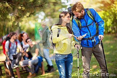 Chap and lassie in friendly conversation about path in forest Stock Photo