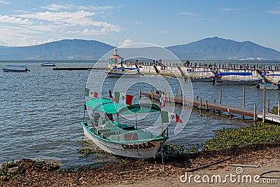 Chapala, Jalisco / Mexico, January 20th, 2020. Boat with Mexican flags moored on the shore of the lake Editorial Stock Photo