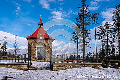 Chapel in the mountains for occasional worship with benches in winter beautiful suns day, czech beskydy , polomy Stock Photo