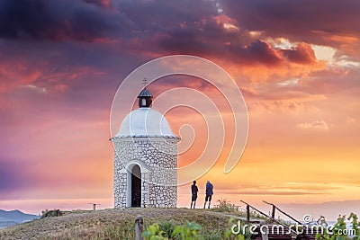 Chapel with pair of people during beautiful sunset in South Moravia Stock Photo