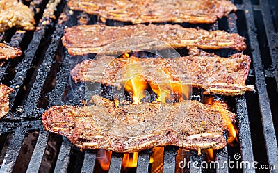 Char-grilled Marinated BBQ Korean Short Ribs on a barbecue grill with open flames Stock Photo
