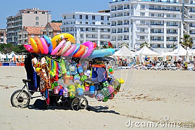 Toys seller cart with plastic toys and beach balls on the sandy beach Editorial Stock Photo