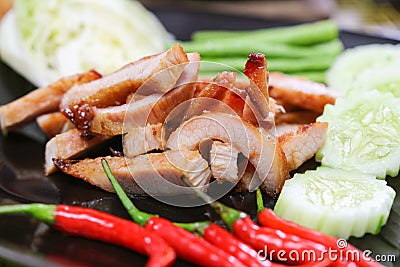 Charcoal-boiled Pork Neck on black plate thai food Stock Photo