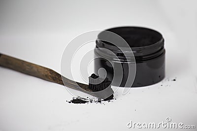 Charcoal on a toothbrush to whiten teeth Stock Photo