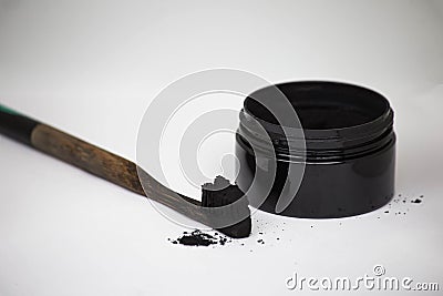 Charcoal on a toothbrush to whiten teeth Stock Photo