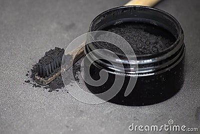 Charcoal on a toothbrush to whiten teeth Stock Photo