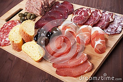 Charcuterie board with cured meat and olives Stock Photo