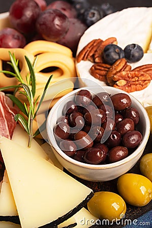 Charcuterie board with olives, cheese, jamon and bread Stock Photo
