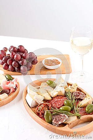 Charcuterie plate with different types of meat snacks - salami, bresaola, proscuitto. Plates with traditional italian antipasti Stock Photo