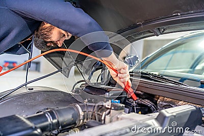 charging the car battery using electric cables Stock Photo