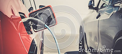 Charging an ecological car with an electric motor at the charging station Stock Photo