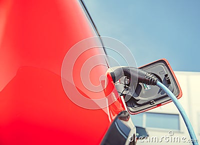 Charging an ecological car with an electric motor at the charging station Stock Photo
