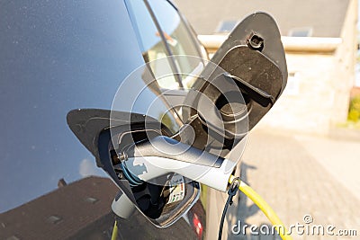 Charging elektric car at home Stock Photo