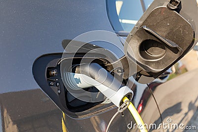 Charging elektric car at home Stock Photo