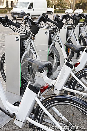 Charging urban electric battery bikes in the city. Eco transport Stock Photo