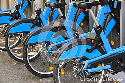 Charging urban electric battery bikes in the city. Sustainable mobility Stock Photo