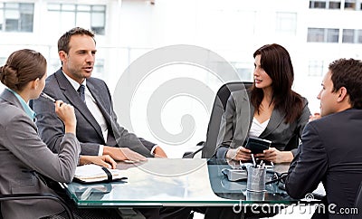 Charismatic businessman talking to his partners Stock Photo