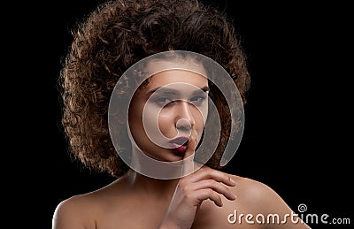Charismatic curly model posing on black background. Stock Photo