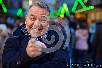 Charismatic man pointing at the camera in glee Stock Photo