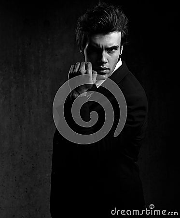 Charismatic male model posing in fashion suit and white sty Stock Photo