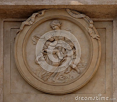 Charity Medallion on the Palazzo Montecitorio, seat of the Italian Chamber of Deputies in Rome Editorial Stock Photo