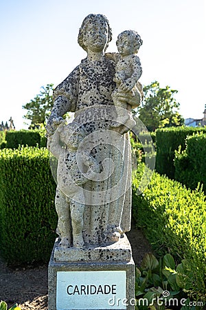 charity represented by stone statue. Episcopal garden of Castelo Branco Stock Photo