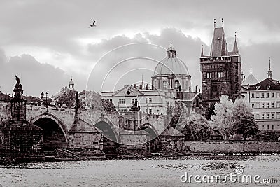 Charles Bridge and Old Prague district with medieval churches and towers in Prague, Czech Republic, in black and white Stock Photo