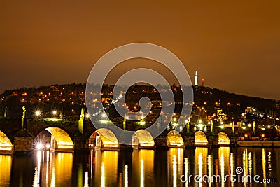 Charles Bridge in Old Town, Prague, Czech Republic at night. Lights. Petrin hill in the background. Stock Photo