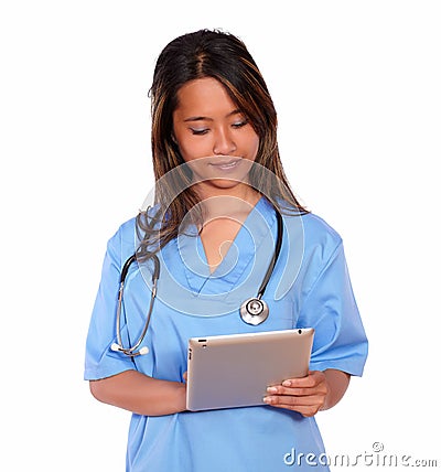 Charming asiatic nurse woman working on tablet pc Stock Photo