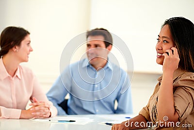 Charming asiatic woman conversing on her cellphone Stock Photo