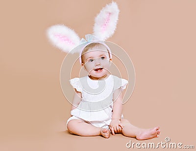 Charming baby sitting in costume easter bunny Stock Photo